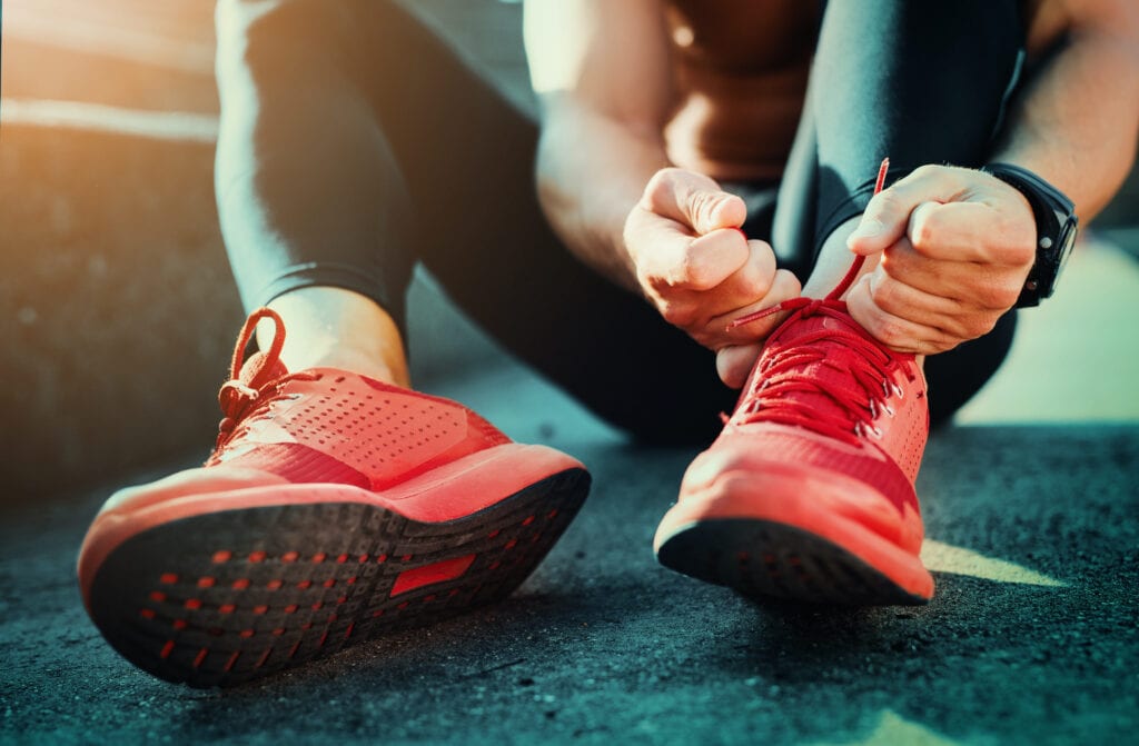 running shoes tied by person