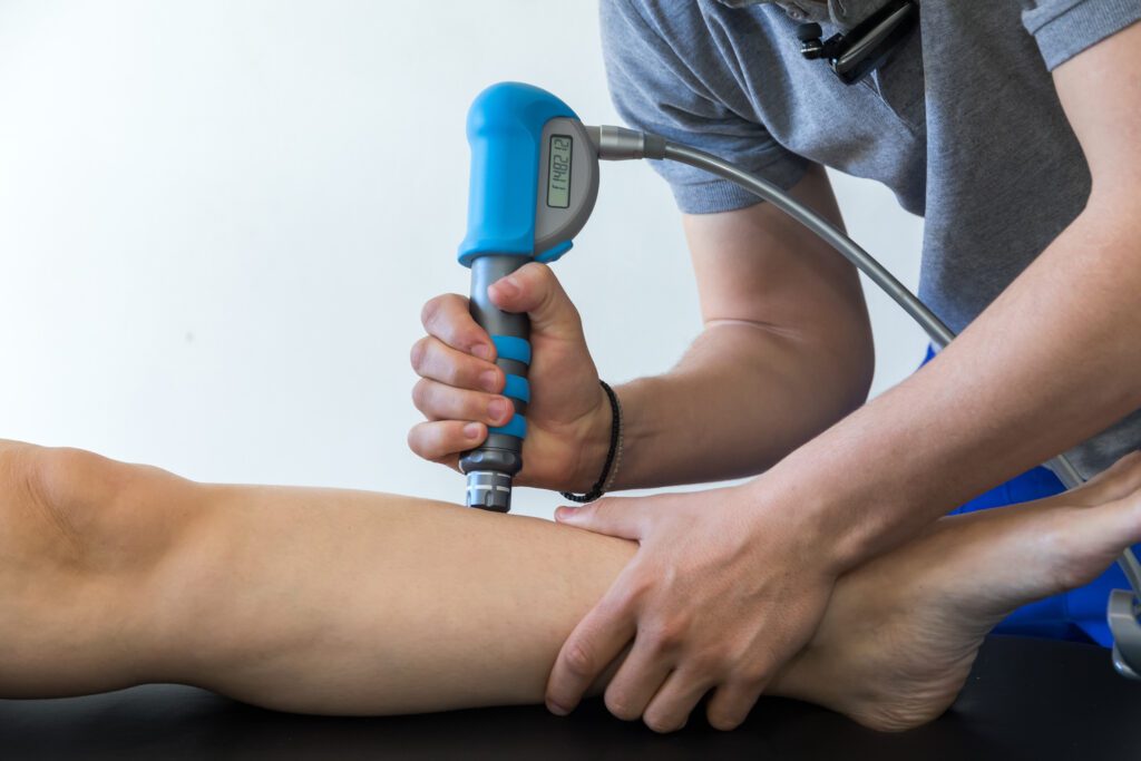 doctor uses shockwave therapy on patient
