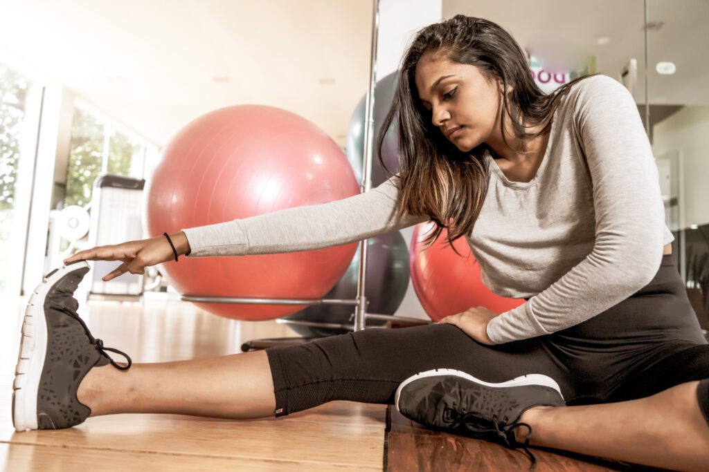 woman completing stretching ankle exercises